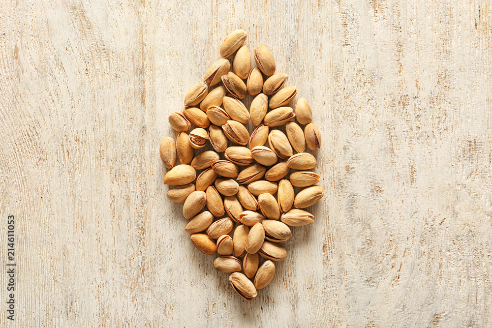 Tasty pistachio nuts on wooden background Tasty pistachio nuts on wooden background