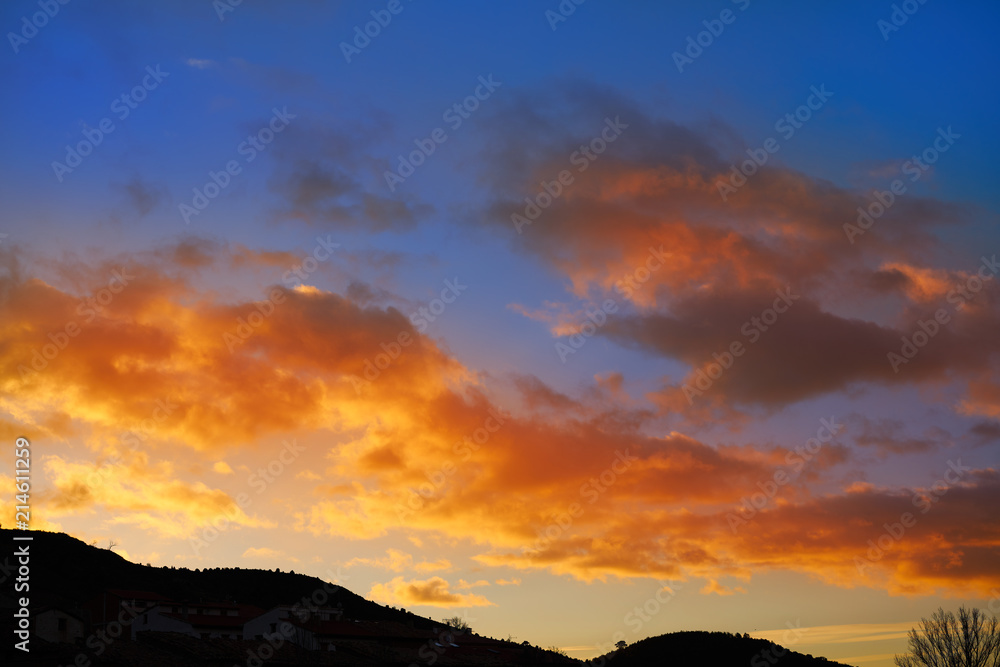 Sunset mountain silhouette with orange clouds