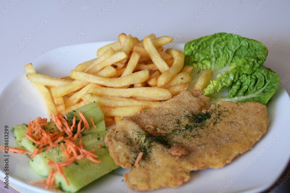 fries and a salad of fresh cucumber and grated carrot fried fish fries and a salad of fresh cucumber and grated carrot fried fish