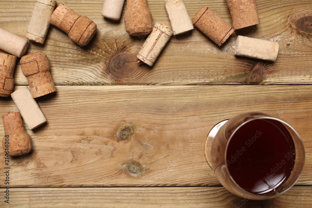group of wine bottle cork and a glass of wine on a wooden table with copy space for your text group of wine bottle cork and a glass of wine on a wooden table with copy space for your text