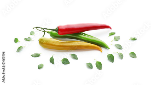 Chili peppers with green oregano on white background