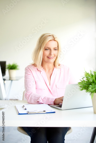Confident woman working from home © gzorgz