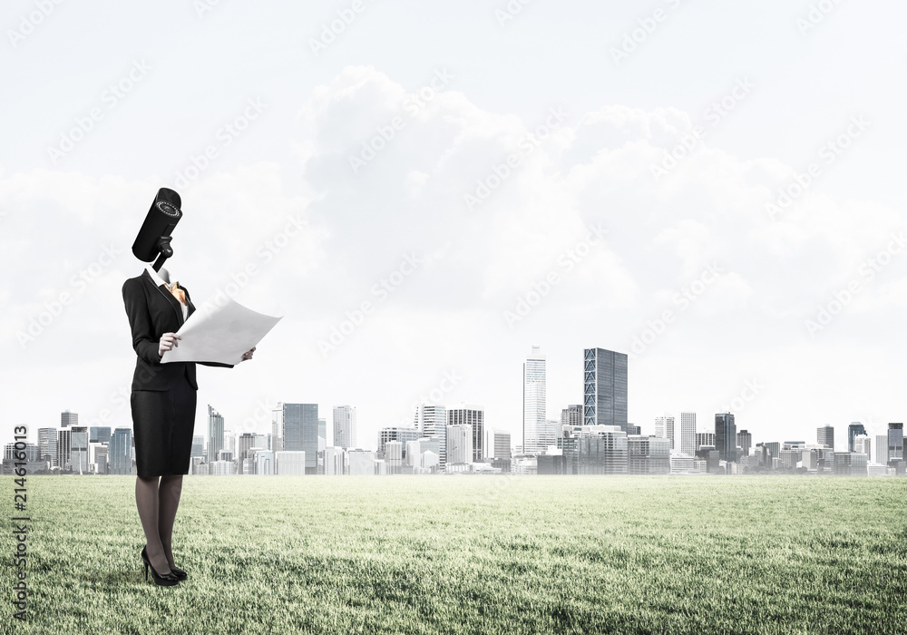 Camera headed woman standing on green grass against modern citys Camera headed woman standing on green grass against modern citys