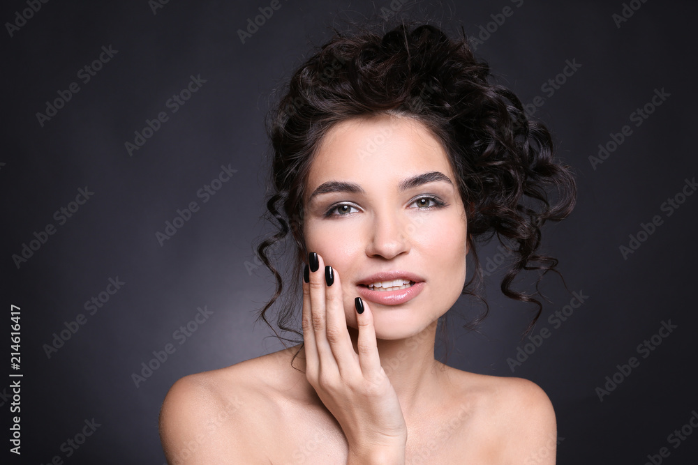 Fashionable young woman with black manicure on dark background Fashionable young woman with black manicure on dark background