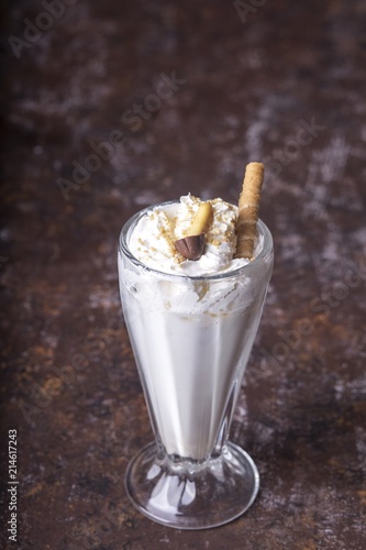 Delicious milkshake on wooden background