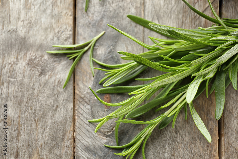 Fresh rosemary on wooden background, closeup