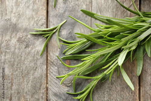 Fresh rosemary on wooden background  closeup