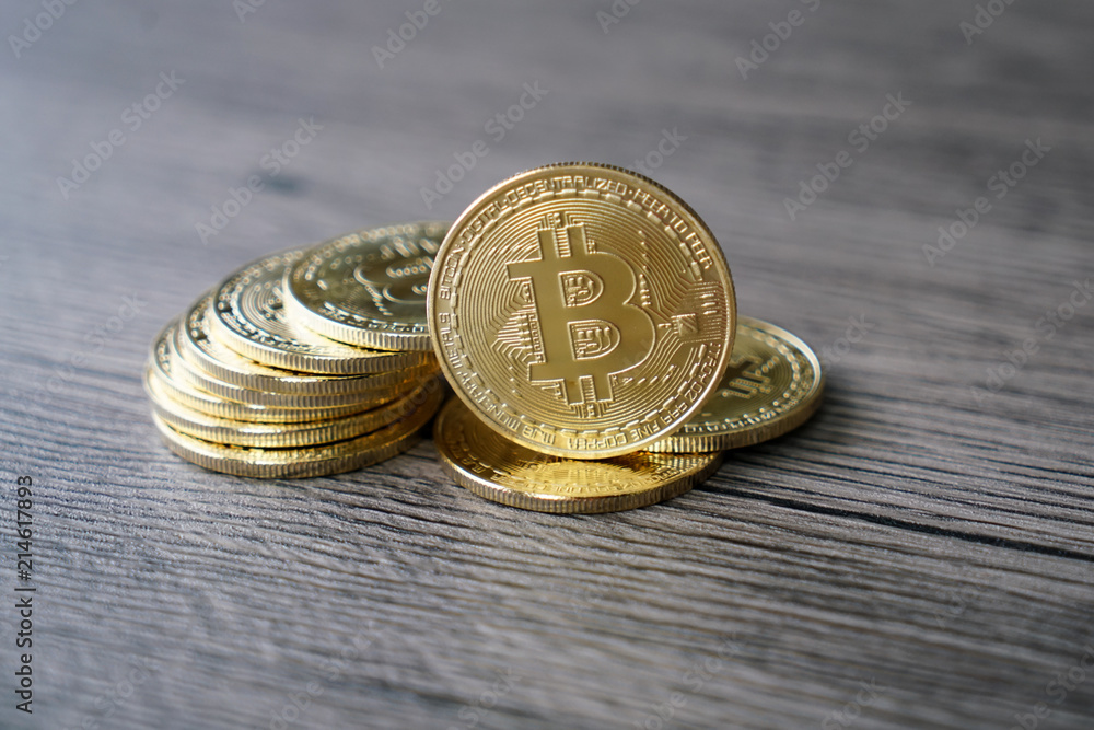 golden bitcoin coin on the wooden table golden bitcoin coin on the wooden table