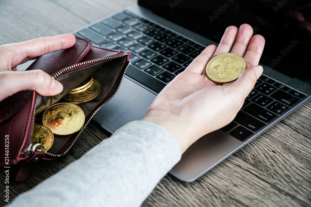 Virtual currency wallet gold bitcoin. bitcoin laptop wallet. Bitcoin in hand.