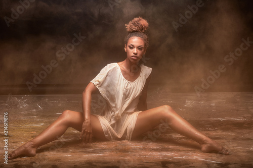 Beautiful afro girl dancer over dust. © neonshot