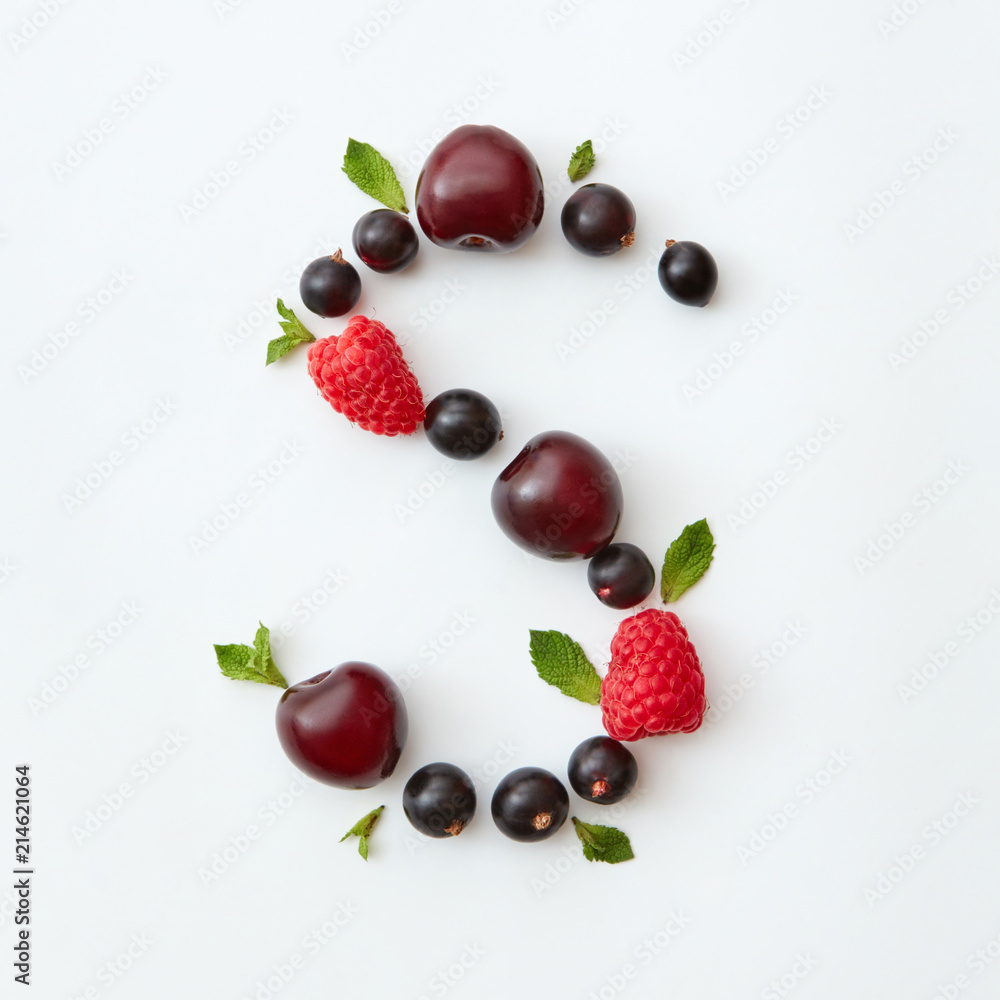 Flat lay pattern of letter S english alphabet from natural ripe berries - black currant, cherries, raspberry, mint leaf isolated on a white background. Flat lay pattern of letter S english alphabet from natural ripe berries - black currant, cherries, raspberry, mint leaf isolated on a white background.