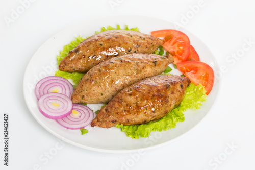 Three fried breaded cutlet with lettuce, tomatoes, cucumbers and onion on white background