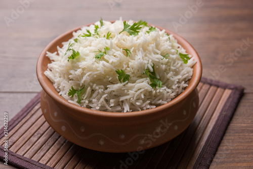 Coriander or cilantro Basmati Rice, served in a ceramic or terracotta bowl. It's a popular Indian OR Chinese recipe. Selective focus
