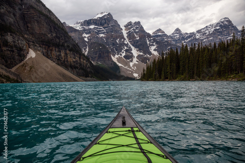 Kayaking in Glacier Water surounded by the beautiful Canadian Rocky Mountains. Taken in Moraine Lake, Banff National Park, Alberta, Canada. © edb3_16