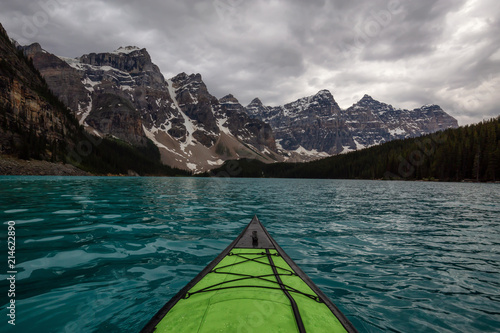 Kayaking in Glacier Water surounded by the beautiful Canadian Rocky Mountains. Taken in Moraine Lake, Banff National Park, Alberta, Canada. © edb3_16