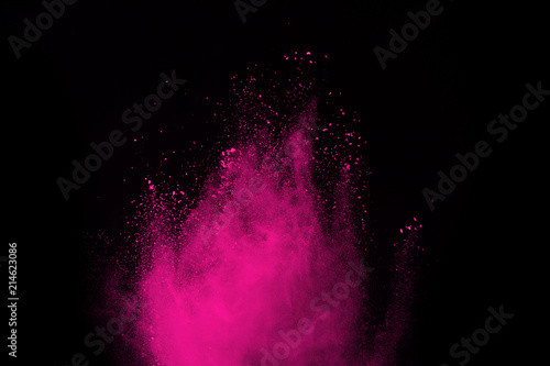 Pink powder explosion isolate on black background. Paint Holi.