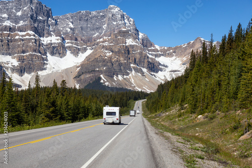Road in Icefields Parkway during a vibrant sunny summer day. Taken in Banff National Park, Alberta, Canada.