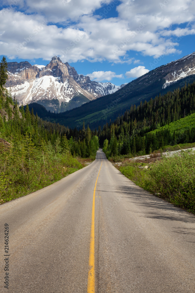Scenic road in the Canadian Rockies during a vibrant sunny summer day. Taken in Yoho National Park, British Columbia, Canada.