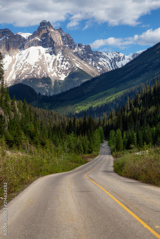 Scenic road in the Canadian Rockies during a vibrant sunny summer day. Taken in Yoho National Park, British Columbia, Canada.