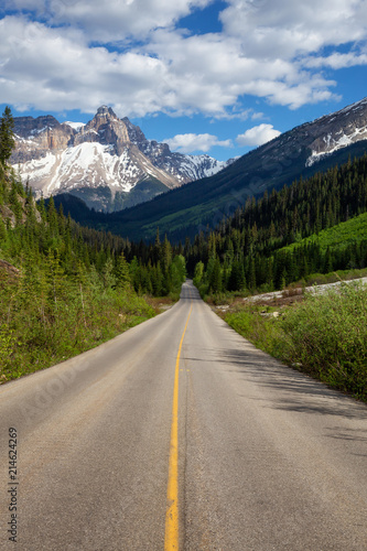 Scenic road in the Canadian Rockies during a vibrant sunny summer day. Taken in Yoho National Park, British Columbia, Canada.