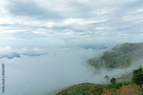 The mountain field during mist sunrise. Beautiful natural landscape in the summer time. Phu Thap Boek, Thailand.