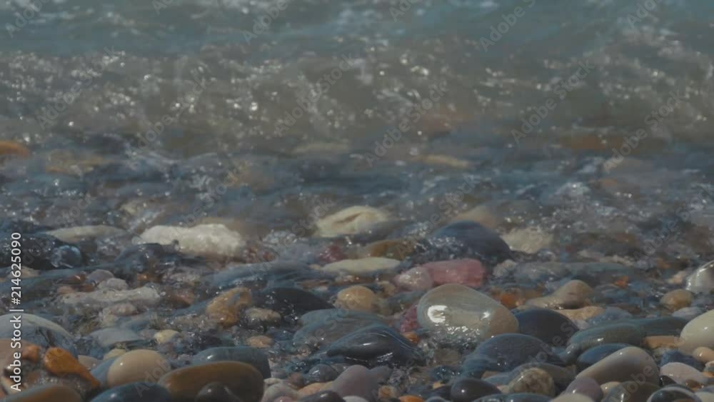Pebble beach of the sea. the waves on the shore are slow. close up. Pebble beach of the sea. the waves on the shore are slow. close up.