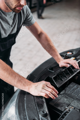 cropped view of auto mechanic repairing car