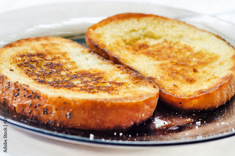 Toasts, two pieces of fried bread on butter Toasts, two pieces of fried bread on butter