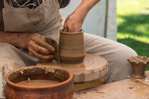 Potter working with clay, making pot