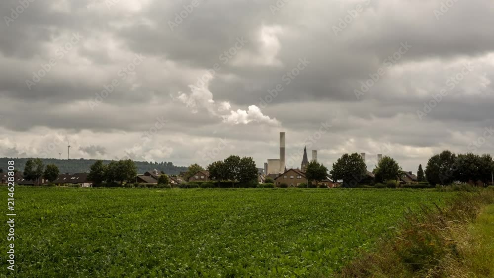 Conceptional time lapse shot combining suburban houses, a rural church and heavy industry in the background. Conceptional time lapse shot combining suburban houses, a rural church and heavy industry in the background.