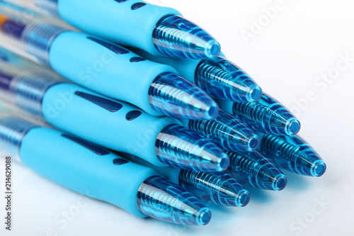 Group of ten blue plastic gel pens on a white background