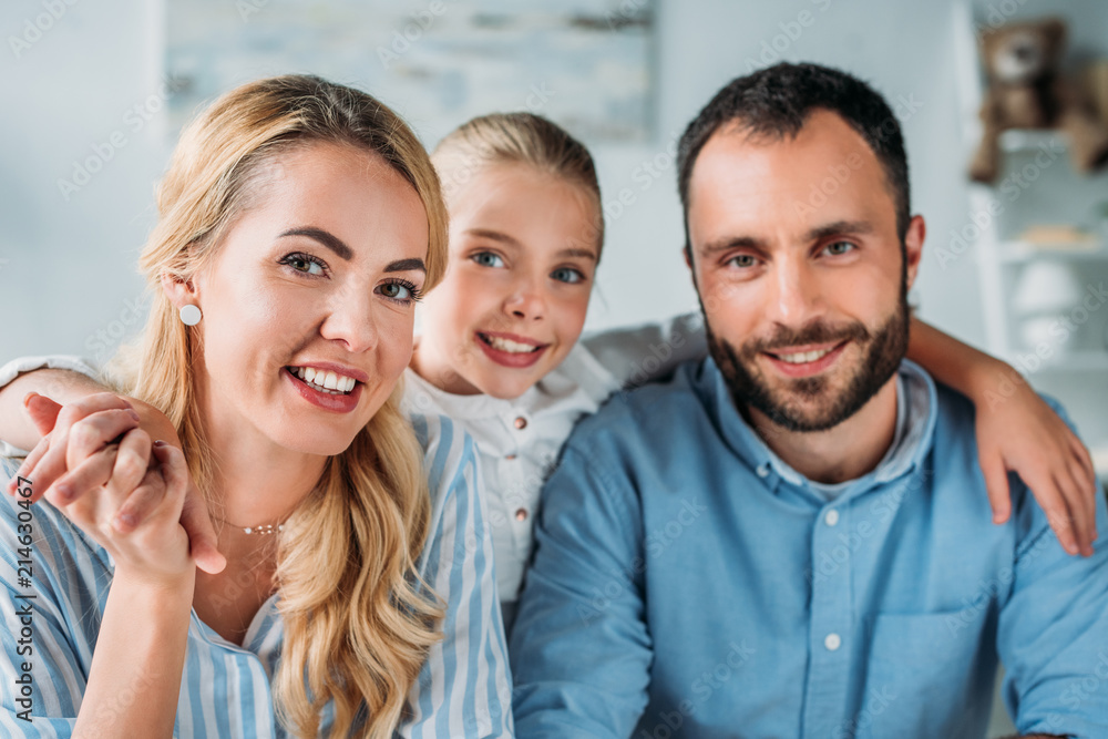 happy young family looking at camera