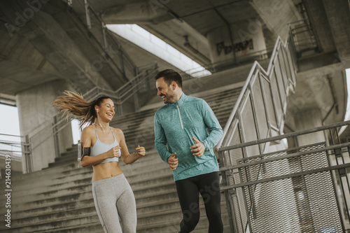 Young couple running in urban enviroment