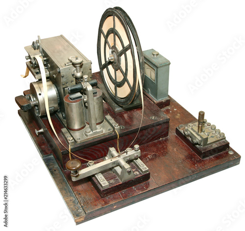 isolated obsolete vintage morse telegraph machine on white background photo