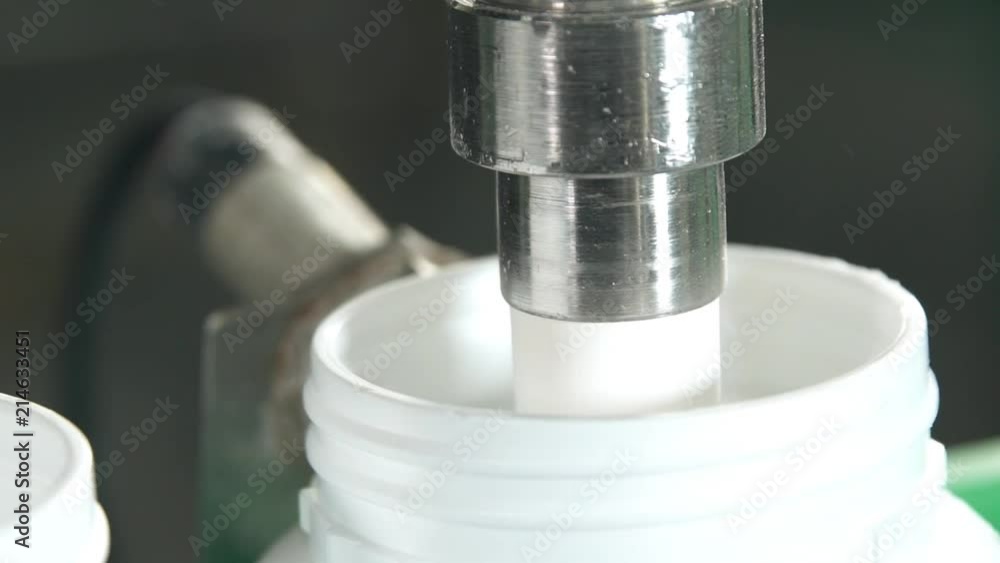 Machine Putting White Powder In White Pots - Close Up - Tilt Down Machine Putting White Powder In White Pots - Close Up - Tilt Down