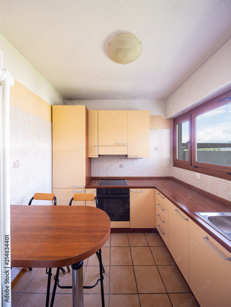 Fototapeta premium Vintage kitchen with window and table with stools