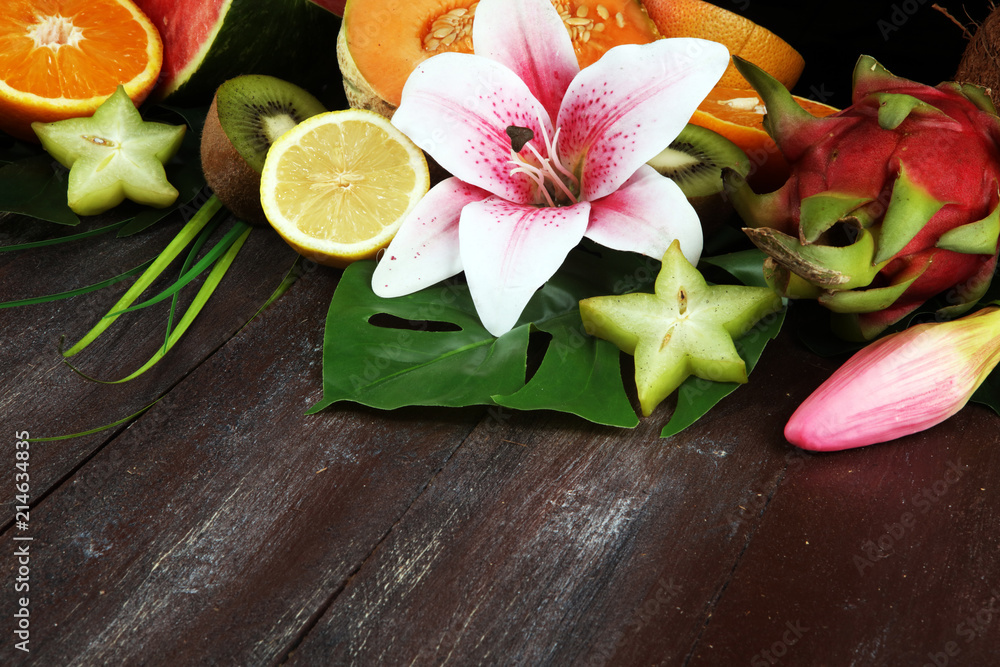 Assortment of tropical fruits with leaves of palm trees and exotic plants Assortment of tropical fruits with leaves of palm trees and exotic plants