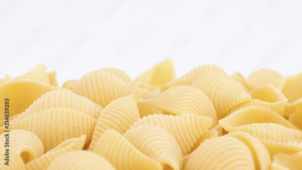Conchiglie pasta rotating on white background, (loopable). 4K UHD