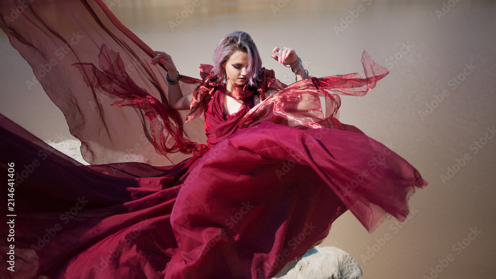 Lady in red. Young beautiful woman, delightful portrait in red flying dress