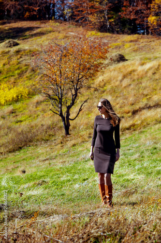 girl colorful autumn forest high mountains carpathians landscape enjoy view perspective sunglasses brown dress sunlight yellow sky blue © NataliAlba