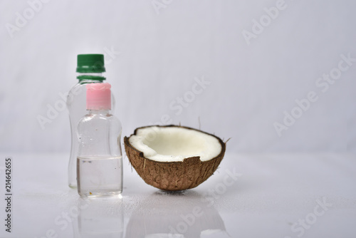 Coconut oil with coconut on grey background. 