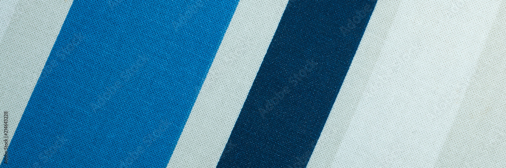 Fototapeta premium Textured with a pattern of diagonal strips of white and shades of blue