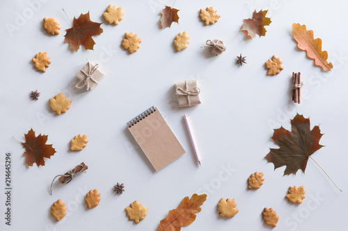 Flat lay, top view of vintage autumn woman office table desk. Workspace with laptop, maple leaves and flowers, diary on white background. Online shopping concept