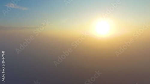 Flight over the clouds at dawn.