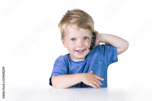 Kids education, developing, technology, mobile phone and internet concept, little child boy using smartphone on white background
