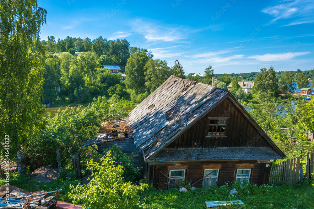 An old wooden house, gone through the window to the ground, Russia. An old wooden house, gone through the window to the ground, Russia.