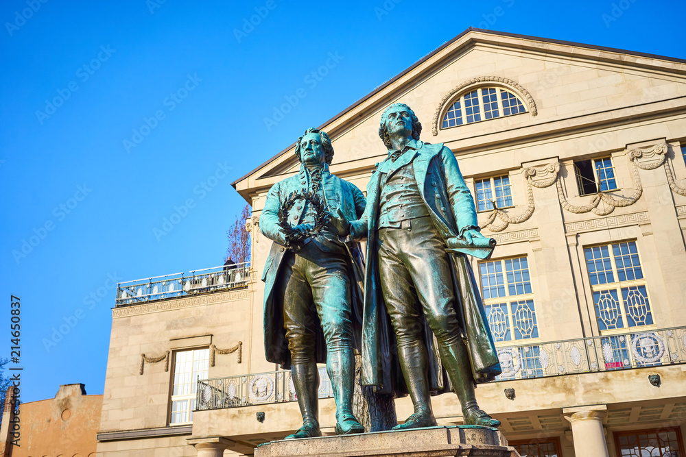 Obraz premium Famous sculpture of Goethe and Schiller in the city of Weimar in Germany / Most famous classical german authors / 18th century