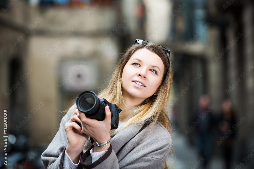 Girl holding camera and photographing
