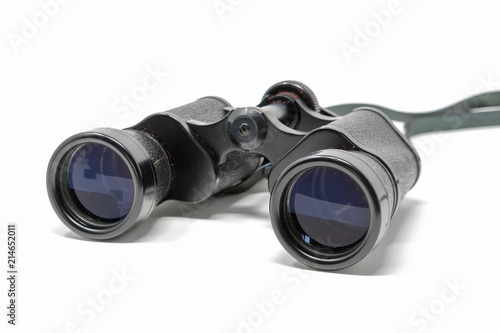 A set of old binoculars set against a white background