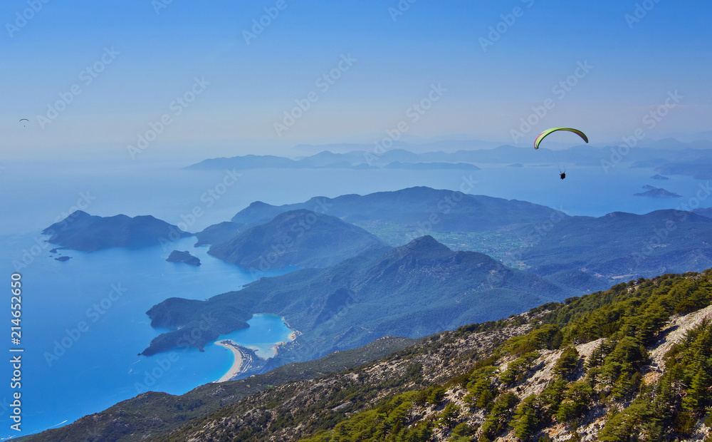 Amazing aerial view of Blue Lagoon in Oludeniz, Turkey. Summer landscape with sea spit, green trees, azure water, sandy beach in bright sunny day. Amazing aerial view of Blue Lagoon in Oludeniz, Turkey. Summer landscape with sea spit, green trees, azure water, sandy beach in bright sunny day.